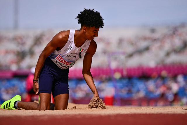 Italy's Mattia Furlani touches his tights after jumping and injuring himself as he competes in the men's long jump qualifier during the European Athletics Championships at Alexander Stadium in Birmingham on August 10, 2026. (Photo by Ben STANSALL / AFP)