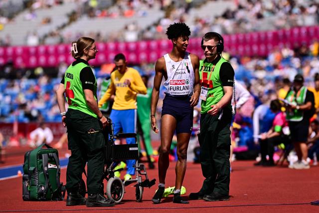 Italy's Mattia Furlani is helped by medics before being evacuated on a wheelchair after injuring himself while competing in the men's long jump qualifier during the European Athletics Championships at Alexander Stadium in Birmingham on August 10, 2026. (Photo by Ben STANSALL / AFP)