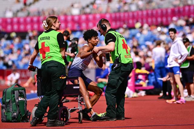 Italy's Mattia Furlani is helped by medics before being evacuated on a wheelchair after injuring hiself while competing in the men's long jump qualifier during the European Athletics Championships at Alexander Stadium in Birmingham on August 10, 2026. (Photo by Ben STANSALL / AFP)