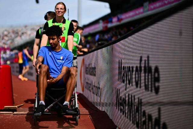 Italy's Mattia Furlani is evacuated on a wheelchair after injuring himself while competing in the men's long jump qualifier during the European Athletics Championships at Alexander Stadium in Birmingham on August 10, 2026. (Photo by Ben STANSALL / AFP)