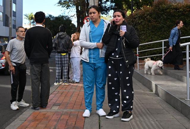 People react as they evacuate after an earthquake in Bogota on August 10, 2026. A strong earthquake struck Colombia on August 10 and was strongly felt in major cities such as Bogota and Cali, and even in Quito and Panama, according to the Colombian Geological Service and as confirmed by AFP reporters. (Photo by Raul ARBOLEDA / AFP)