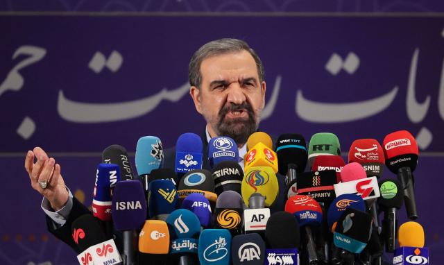(FILES) Iranian former chief of the Revolutionary Guards Mohsen Rezaei talks to the media after registering his candidacy for the June presidential elections, at the Interior Ministry in the capital Tehran, on May 15, 2021. The former commander in chief of Iran's Revolutionary Guards, Mohsen Rezaei, has been named head of the country's highest national security body, the Iranian presidency announced on August 9, 2026. Rezaei, 71, led the Guards from 1981 to 1997 -- a tenure that included almost all of the Iran-Iraq war -- before going on to occupy several high-ranking political posts. He then served as military adviser to supreme leader Ayatollah Mojtaba Khamenei. (Photo by ATTA KENARE / AFP)