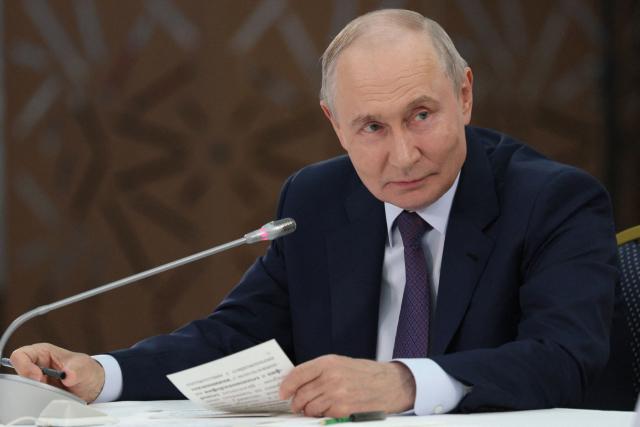 In this pool photograph distributed by the Russian state agency Sputnik, Russia's President Vladimir Putin attends a meeting with urban planners in Ulan-Ude on August 10, 2026. (Photo by Gavriil Grigorov / POOL / AFP)
