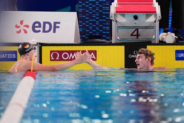 Neutral Athlete B's Ilia Borodin (R) reacts with Germany's Finn Hammer after winning the final of the men's 400m individual medley swimming event during the LEN European Aquatics Championships at the Olympic Aquatic Centre in Saint-Denis, northern suburbs of Paris, on August 10, 2026. (Photo by Dimitar DILKOFF / AFP)