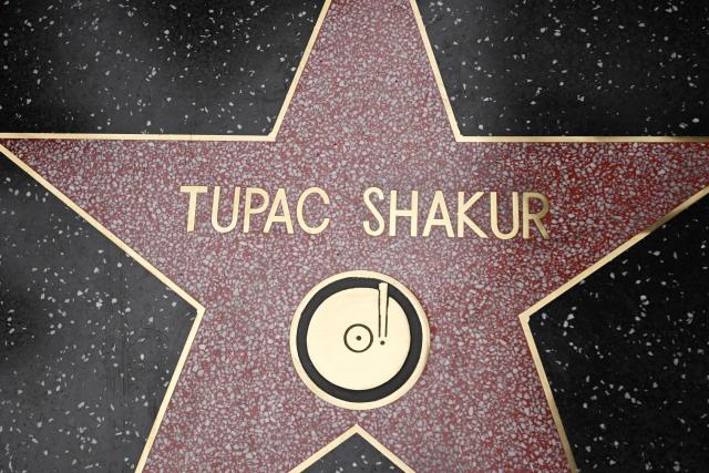 (FILES) The newly unveiled star of late US rapper Tupac Shakur is seen during his Hollywood Walk of Fame star ceremony in Hollywood, California, on June 7, 2023. A former gang leader goes on trial on August 10, 2026 in Las Vegas over the decades-old murder of rapper Tupac Shakur, one of America's most high-profile unresolved murders. The proceedings, expected to last a month, will likely not make clear who fired the shots that killed the hip-hop legend on the night of September 7, 1996 while he was in Sin City to see a Mike Tyson boxing match. (Photo by Robyn Beck / AFP)