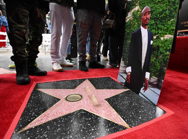 (FILES) A portrait of late US rapper Tupac Shakur is displayed at his unveiled star on the Hollywood Walk of Fame ceremony in Hollywood, California, on June 7, 2023. A former gang leader goes on trial on August 10, 2026 in Las Vegas over the decades-old murder of rapper Tupac Shakur, one of America's most high-profile unresolved murders. The proceedings, expected to last a month, will likely not make clear who fired the shots that killed the hip-hop legend on the night of September 7, 1996 while he was in Sin City to see a Mike Tyson boxing match. (Photo by Robyn BECK / AFP)