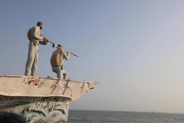A sculpture overlooking the Strait of Hormuz is seen along the seafront in the port city of Bandar Abbas, in southern Iran on August 10, 2026. The US President signalled on August 9 that he was prepared to let economic pressure mount against Iran, apparently backing away from more military strikes after Tehran issued a list of demands for opening the Strait of Hormuz. His remarks came after Iran issued over the weekend a list of conditions to reopen the Strait of Hormuz, which has remained largely closed since the start of the Middle East war in late February. (Photo by Atta KENARE / AFP) / 
