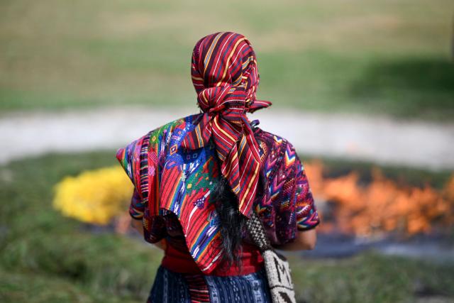 An indegenous woman takes part in a Mayan ceremony commemorating the International Day of the World's Indigenous Peoples, at the archaeological site of Kaminal Juyu, in Guatemala City on August 10, 2026. (Photo by Johan ORDONEZ / AFP)
