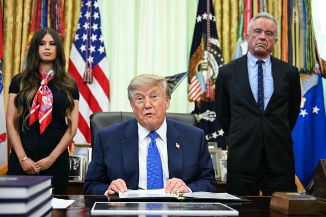 US Secretary of Health and Human Services Robert F. Kennedy Jr. (R) looks on as President Donald Trump speaks before signing an executive order calling for more research and flexibility on vaccines, in the Oval Office of the White House in Washington, DC, on August 10, 2026. (Photo by Jim WATSON / AFP)