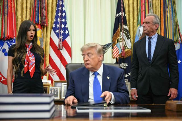 US Secretary of Health and Human Services Robert F. Kennedy Jr. (R) and Jayme Leagh Franklin (L), founder of The Conservateur, look on before President Donald Trump signs an executive order calling for more research and flexibility on vaccines, in the Oval Office of the White House in Washington, DC, on August 10, 2026. (Photo by Jim WATSON / AFP)
