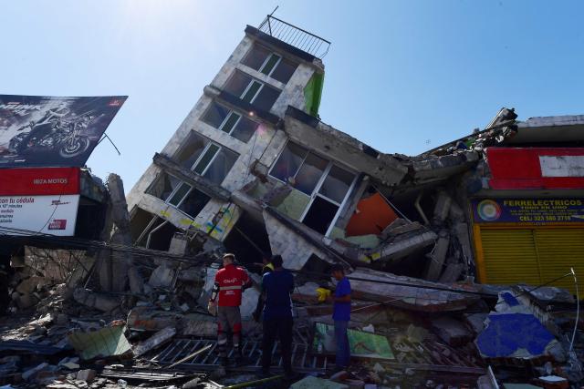 People look for survivors amid the rubble of a collapsed building after an earthquake in Pereira, Colombia on August 10, 2026. A powerful earthquake rocked Colombia and neighboring Latin American countries on August 10, 2026, with medical teams rushing to help victims after buildings were damaged or collapsed in several cities. The Colombian geological service and its American counterpart USGS put the magnitude at 7.4, with an epicenter 100 km (60 miles) underground in the west of the country. Colombia had initially put it at 6.6. (Photo by Jaime SALDARRIAGA / AFP)