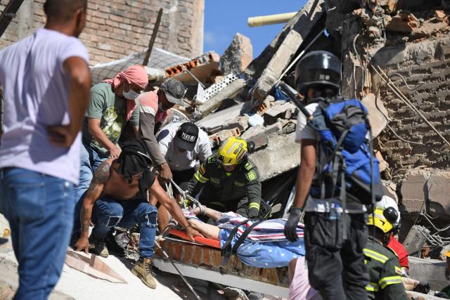 EDITORS NOTE: Graphic content / Rescuers recover a corpse from the rubble of a collapsed building after an earthquake in Pereira, Colombia on August 10, 2026. A powerful earthquake rocked Colombia and neighboring Latin American countries on August 10, 2026, with medical teams rushing to help victims after buildings were damaged or collapsed in several cities. The Colombian geological service and its American counterpart USGS put the magnitude at 7.4, with an epicenter 100 km (60 miles) underground in the west of the country. Colombia had initially put it at 6.6. (Photo by Jaime SALDARRIAGA / AFP)