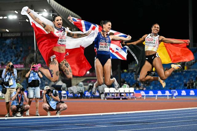 (From L) Silver medallist Poland's Ewa Swoboda, gold medallist Britain's Amy Hunt and Belgium's Delphine Nkansa celebrate after competing in the women's 100m final during the European Athletics Championships at Alexander Stadium in Birmingham on August 10, 2026. (Photo by Paul ELLIS / AFP)