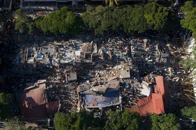 This aerial view shows a a collapsed building after an earthquake in Cali, Colombia on August 10, 2026. A magnitude 7.4 earthquake struck Colombia on August 10, 2026, and killed at least 111 people, damaged more than 1,500 buildings, and left an unknown number of people buried under rubble. The government declared a state of emergency to attend to the quake that shook several cities across the coffee-producing region, the Pacific coast, and neighboring Latin American countries, sending terrified residents racing into the street. (Photo by Joaquín SARMIENTO / AFP)