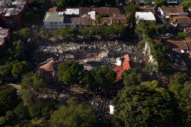 This aerial view shows a a collapsed building after an earthquake in Cali, Colombia on August 10, 2026. A magnitude 7.4 earthquake struck Colombia on August 10, 2026, and killed at least 111 people, damaged more than 1,500 buildings, and left an unknown number of people buried under rubble. The government declared a state of emergency to attend to the quake that shook several cities across the coffee-producing region, the Pacific coast, and neighboring Latin American countries, sending terrified residents racing into the street. (Photo by Joaquín SARMIENTO / AFP)