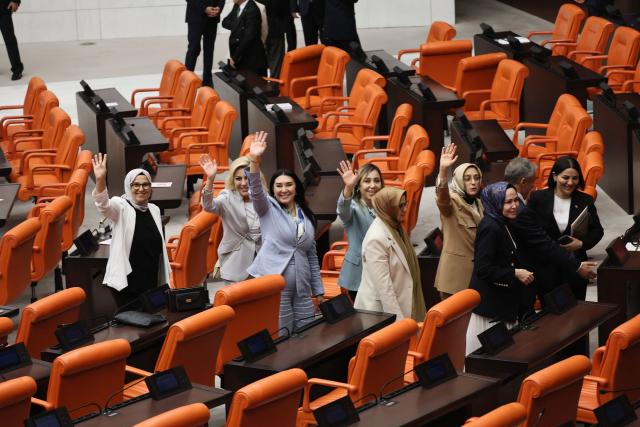 Lawmakers from Turkey's Justice and Development Party (AKP) gesture after taking part in a voting session on a bill offering limited amnesty to Kurdish PKK militants at the Grand National Assembly of Turkey in Ankara on August 10, 2026. Turkish lawmakers on August 10, 2026, voted through a bill offering limited amnesty for Kurdish PKK militants in a first legislative step to end decades of deadly violence, footage from parliament showed. The bill offering limited amnesty to Kurdish fighters remained silent on the fate of jailed PKK leader Abdullah Ocalan, who championed the process. (Photo by Adem ALTAN / AFP)