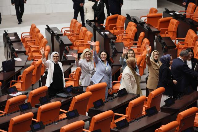 Lawmakers from Turkey's Justice and Development Party (AKP) gesture after taking part in a voting session on a bill offering limited amnesty to Kurdish PKK militants at the Grand National Assembly of Turkey in Ankara on August 10, 2026. Turkish lawmakers on August 10, 2026, voted through a bill offering limited amnesty for Kurdish PKK militants in a first legislative step to end decades of deadly violence, footage from parliament showed. The bill offering limited amnesty to Kurdish fighters remained silent on the fate of jailed PKK leader Abdullah Ocalan, who championed the process. (Photo by Adem ALTAN / AFP)