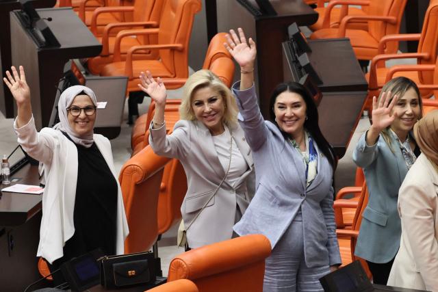 Lawmakers from Turkey's Justice and Development Party (AKP) gesture after taking part in a voting session on a bill offering limited amnesty to Kurdish PKK militants at the Grand National Assembly of Turkey in Ankara on August 10, 2026. Turkish lawmakers on August 10, 2026, voted through a bill offering limited amnesty for Kurdish PKK militants in a first legislative step to end decades of deadly violence, footage from parliament showed. The bill offering limited amnesty to Kurdish fighters remained silent on the fate of jailed PKK leader Abdullah Ocalan, who championed the process. (Photo by Adem ALTAN / AFP)