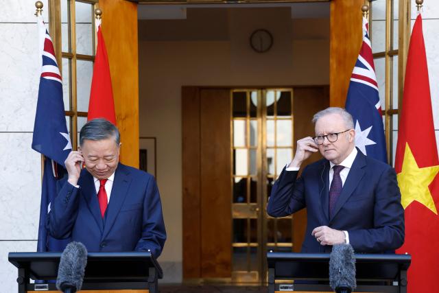 Vietnamese General Secretary and President To Lam (L) and Australian Prime Minister Anthony Albanese adjust their earpieces as they attend a joint press conference at Parliament House in Canberra on August 11, 2026. (Photo by hilary wardhaugh / AFP)