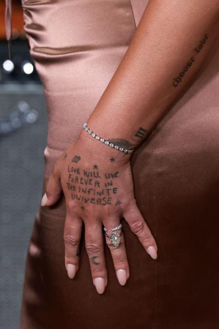 US actress, singer and songwriter Demi Lovato (tattoo detail) attends Disney's "Camp Rock 3" premiere at The Walt Disney Studio Lot in Burbank, California, on August 10, 2026. (Photo by VALERIE MACON / AFP)