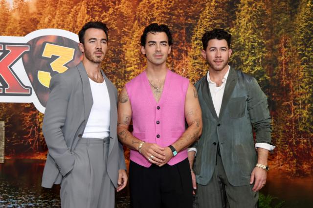 (L-R) US singers, songwriters and executive producers Kevin Jonas, Joe Jonas and Nick Jonas attend Disney's "Camp Rock 3" premiere at The Walt Disney Studio Lot in Burbank, California, on August 10, 2026. (Photo by VALERIE MACON / AFP)