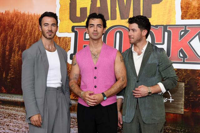 (L-R) US singers, songwriters and executive producers Kevin Jonas, Joe Jonas and Nick Jonas attend Disney's "Camp Rock 3" premiere at The Walt Disney Studio Lot in Burbank, California, on August 10, 2026. (Photo by VALERIE MACON / AFP)