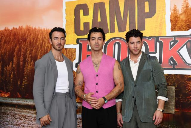 (L-R) US singers, songwriters and executive producers Kevin Jonas, Joe Jonas and Nick Jonas attend Disney's "Camp Rock 3" premiere at The Walt Disney Studio Lot in Burbank, California, on August 10, 2026. (Photo by VALERIE MACON / AFP)