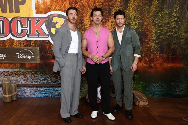 (L-R) US singers, songwriters and executive producers Kevin Jonas, Joe Jonas and Nick Jonas attend Disney's "Camp Rock 3" premiere at The Walt Disney Studio Lot in Burbank, California, on August 10, 2026. (Photo by VALERIE MACON / AFP)