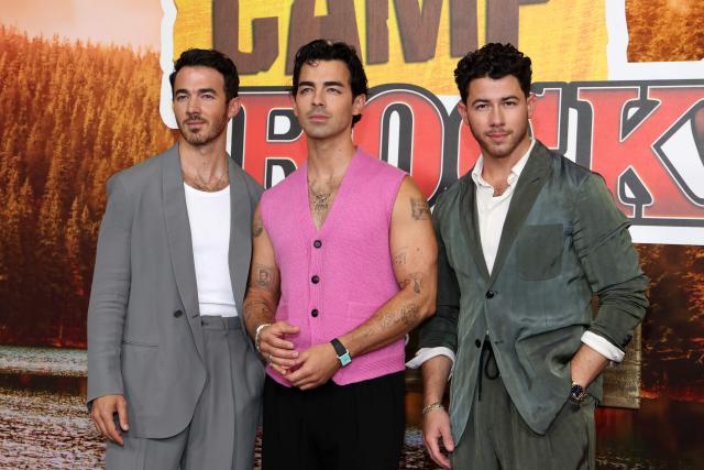 (L-R) US singers, songwriters and executive producers Kevin Jonas, Joe Jonas and Nick Jonas attend Disney's "Camp Rock 3" premiere at The Walt Disney Studio Lot in Burbank, California, on August 10, 2026. (Photo by VALERIE MACON / AFP)
