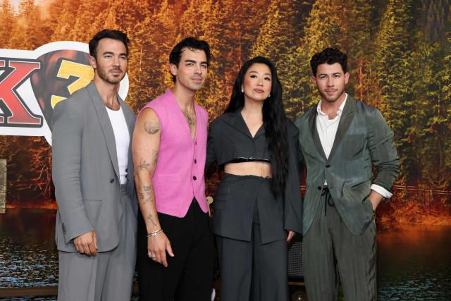 US actress and comedian Sherry Cola (C-R), US singers, songwriters and executive producers Kevin Jonas (L), Nick Jonas (R) and Joe Jonas attend Disney's "Camp Rock 3" premiere at The Walt Disney Studio Lot in Burbank, California, on August 10, 2026. (Photo by VALERIE MACON / AFP)