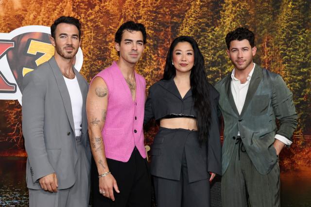 US actress and comedian Sherry Cola (C-R), US singers, songwriters and executive producers Kevin Jonas (L), Nick Jonas (R) and Joe Jonas attend Disney's "Camp Rock 3" premiere at The Walt Disney Studio Lot in Burbank, California, on August 10, 2026. (Photo by VALERIE MACON / AFP)