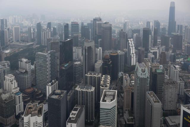 Commercial buildings are covered in haze in Kuala Lumpur on August 11, 2026, as authorities in Malaysia warned of high levels of air pollution from regional wildfires. The Malaysian Meteorological Department urged people on August 11 affected by air pollution to stay indoors, with director-general Mohd Hisham Mohd Anip blaming a "cross-border haze phenomenon from Kalimantan," the Indonesian portion of the island of Borneo. (Photo by Mohd Rasfan / AFP)