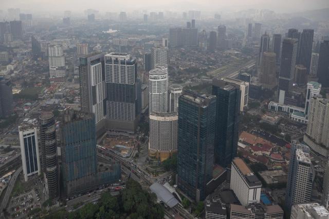 Commercial buildings are covered in haze in Kuala Lumpur on August 11, 2026, as authorities in Malaysia warned of high levels of air pollution from regional wildfires. The Malaysian Meteorological Department urged people on August 11 affected by air pollution to stay indoors, with director-general Mohd Hisham Mohd Anip blaming a "cross-border haze phenomenon from Kalimantan," the Indonesian portion of the island of Borneo. (Photo by Mohd Rasfan / AFP)