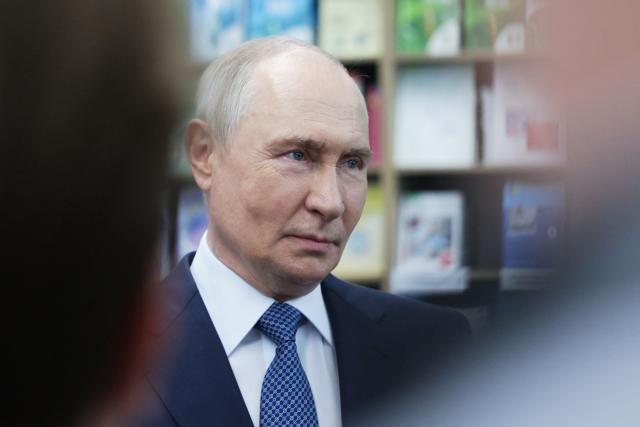 In this pool photograph distributed by the Russian state agency Sputnik, Russia's President Vladimir Putin meets with students, postgraduates and young scientists of the Novosibirsk region in Novosibirsk on August 11, 2026. (Photo by Gavriil Grigorov / POOL / AFP)