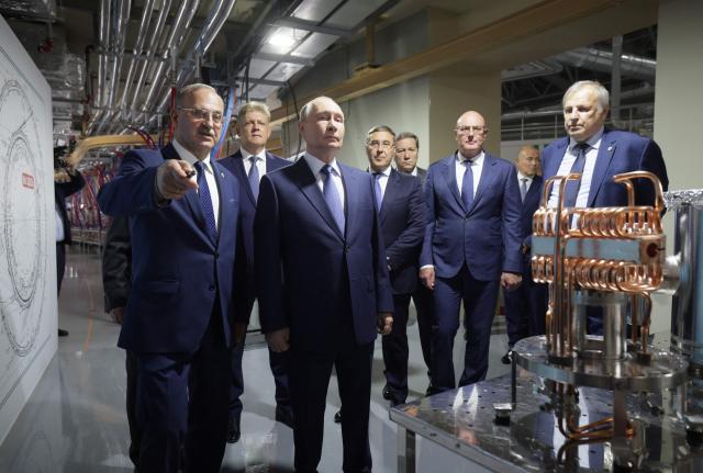 In this pool photograph distributed by the Russian state agency Sputnik, Russia's President Vladimir Putin visits the Siberian Circular Photon Source synchrotron radiation facility outside Novosibirsk on August 11, 2026. (Photo by Gavriil Grigorov / POOL / AFP)