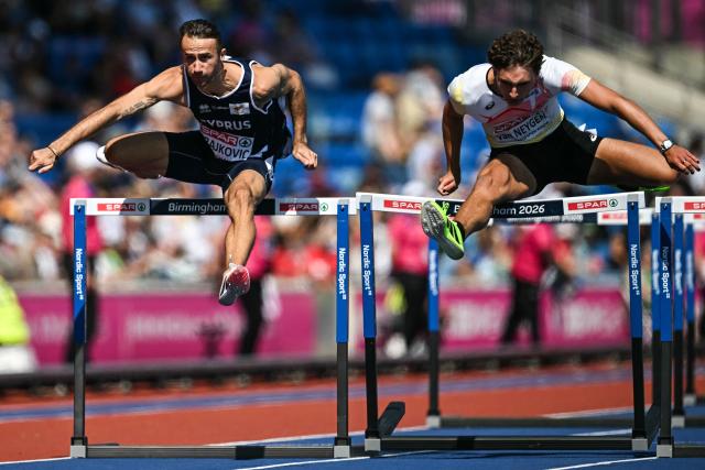 First-placed Cyprus' Milan Trajkovic (L) and second-placed Belgium's Zeno Van Neygen (R) compete in the men's 110m hurdles heat 2 during the European Athletics Championships at Alexander Stadium in Birmingham on August 11, 2026. (Photo by Paul ELLIS / AFP)