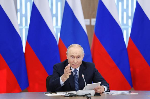 In this pool photograph distributed by the Russian state agency Sputnik, Russia's President Vladimir Putin chairs a meeting of the Council for Science and Education in the Novosibirsk region on August 11, 2026. (Photo by Gavriil Grigorov / POOL / AFP)