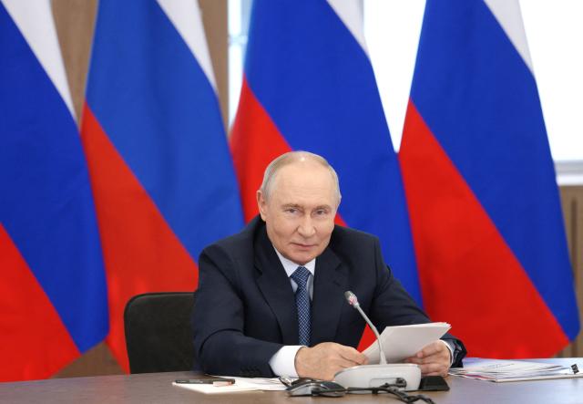 In this pool photograph distributed by the Russian state agency Sputnik, Russia's President Vladimir Putin chairs a meeting of the Council for Science and Education in the Novosibirsk region on August 11, 2026. (Photo by Gavriil Grigorov / POOL / AFP)