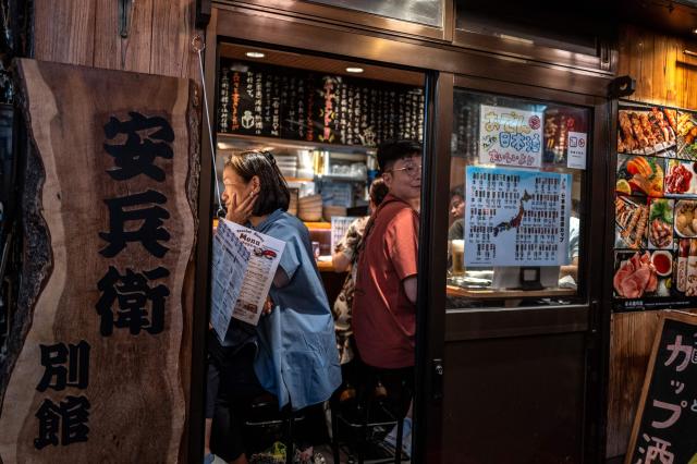 Diners visit a restaurant in Shinjuku district in Tokyo on August 11, 2026. (Photo by Philip FONG / AFP)