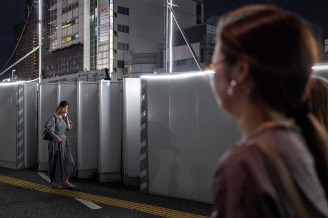 Pedestrians walk along a street in Shinjuku district in Tokyo on August 11, 2026. (Photo by Philip FONG / AFP)