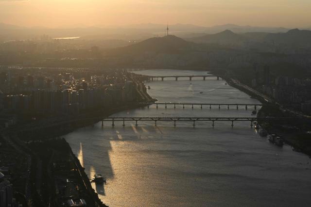 The Han river and the Seoul Tower (top) are seen from the Lotte World Tower at sunset in Seoul on August 11, 2026. (Photo by GREG BAKER / AFP)