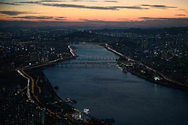 The Han river and the Seoul Tower (top) are seen from the Lotte World Tower at sunset in Seoul on August 11, 2026. (Photo by GREG BAKER / AFP)
