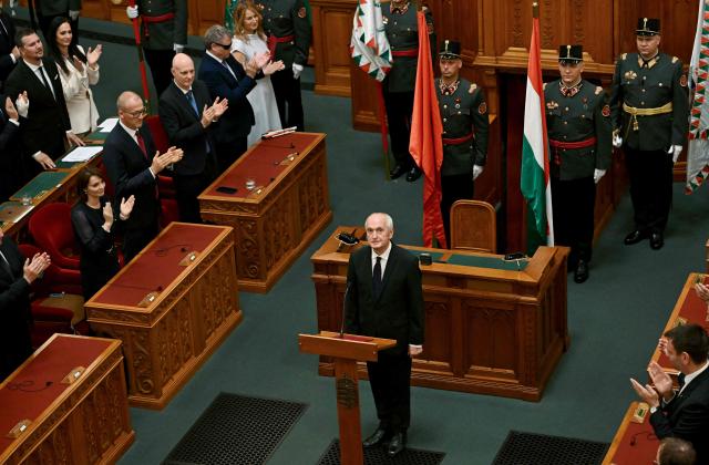 Hungary's newly elected President Andras Baka (C) is applauded after he was elected at the parliament in Budapest on August 11, 2026. Hungarian lawmakers elected former supreme court chief Andras Baka, who was fired under ex-premier Viktor Orban, as the country's next head of state. The post became vacant following the contested removal of the previous president Tamas Sulyok, an Orban ally, as pro-EU conservative Prime Minister Peter Magyar pushes to loosen his predecessor's lingering hold over state institutions. Magyar's ruling Tisza party nominated Baka -- who served 17 years as a judge on the European Court of Human Rights (ECHR) -- for the largely ceremonial role. Magyar's party won April 2026 elections, ending nationalist Orban's 16 years in power and promising "system change". (Photo by Attila KISBENEDEK / AFP)
