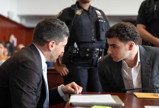 Luigi Mangione (R), accused of the murder of United Healthcare CEO Brian Thompson, speaks with one of his attorneys as he appears for a pre-trial hearing at Manhattan Criminal Court in New York, on August 11, 2026. (Photo by Barry Williams / POOL / AFP)