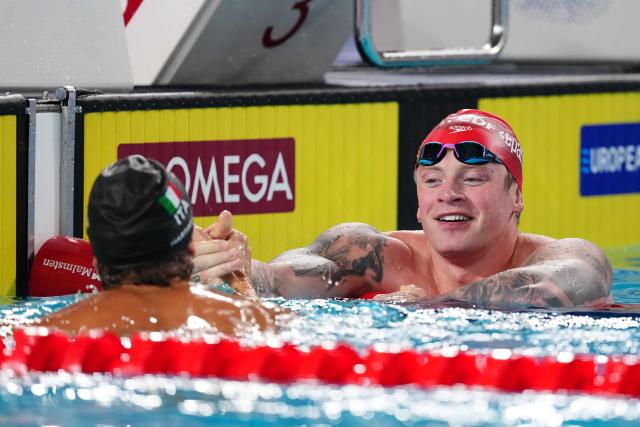 Britain's Adam Ramsay-Peaty (R) reacts with winner Italy's Nicolo Martinenghi after the final of the men's 100m breaststroke swimming event during the LEN European Aquatics Championships at the Olympic Aquatic Centre in Saint-Denis, northern suburbs of Paris, on August 11, 2026. (Photo by SEBASTIEN BOZON / AFP)
