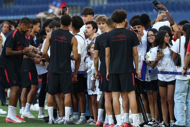 Paris Saint-Germain's players including French forward #29 Bradley Barcola (L) sign autographs for fans at the end of a training session on August 11, 2026, the eve of the UEFA Supercup football match between Champions League winners Paris Saint Germain (PSG) and Europa League winners Aston Villa in Salzburg, Austria. (Photo by FRANCK FIFE / AFP)