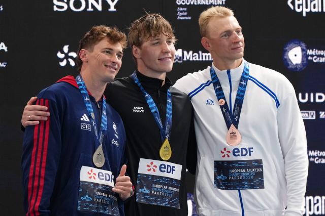 (LtoR) France's Maxime Grousset (silver medal), Neutral Athlete B's Egor Kornev (gold medal) and Neutral Athlete A's Grigori Pekarski (bronze medal) pose on the podium of the men's 50m butterfly swimming event during the LEN European Aquatics Championships at the Olympic Aquatic Centre in Saint-Denis, northern suburbs of Paris, on August 11, 2026. (Photo by Dimitar DILKOFF / AFP)