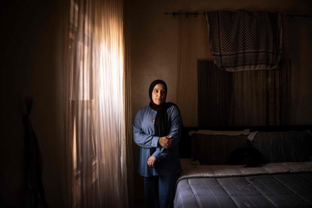 Palestinian woman Nihan Al-Naasan, mother of fifteen-year-old Mohammed Saad, who was shot and killed by Israeli forces outside a mosque during Friday prayers, stands for a portrait in her son's bedroom in Turmus Ayya, in the occupied West Bank, on August 2, 2026. B'Tselem, an Israeli rights group, reported 235 underage deaths at the hands of Israeli forces in the West Bank in the Palestinian territory since October 7, 2023, when Hamas launched a massive attack on Israel from the Gaza Strip, through June 2026, including five killed by Israeli settlers. The Palestinian Wall and Resistance Commission, a Palestinian government institution, reported 250 such deaths over the same time period. (Photo by JOHN WESSELS / AFP) / To go with 'Palestinian-Israel-Conflict-WestBank', REPORTAGE