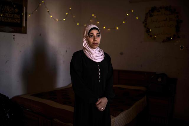 Palestinian woman Sujood Hamdan, mother of eleven-year-old Abdullah, who was killed after being shot by Israeli forces during a military raid, stands for a portrait in front of her son's bed in Nablus, in the occupied West Bank, on July 10, 2026. B'Tselem, an Israeli rights group, reported 235 underage deaths at the hands of Israeli forces in the West Bank in the Palestinian territory since October 7, 2023, when Hamas launched a massive attack on Israel from the Gaza Strip, through June 2026, including five killed by Israeli settlers. The Palestinian Wall and Resistance Commission, a Palestinian government institution, reported 250 such deaths over the same time period. (Photo by JOHN WESSELS / AFP) / To go with 'Palestinian-Israel-Conflict-WestBank', REPORTAGE
