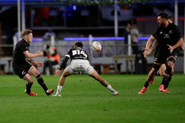 New Zealand's fullback Damian McKenzie (L) passes the ball to New Zealand's lock Josh Lord (R) during a rugby union tour match between The Sharks and New Zealand at Kings Park Stadium in Durban on August 11, 2026. (Photo by PHILL MAGAKOE / AFP)
